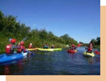 a group of people kayaking on a river in ireland